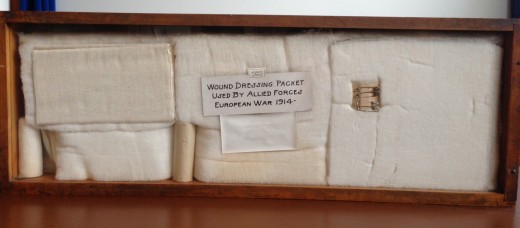 Shadowbox in the Johnson & Johnson Museum showing wound dressing packet developed by Johnson & Johnson during the war. 