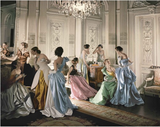 Eight models wearing Charles James gowns, in French & Company's eighteenth century French paneled room.